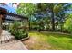 Lush backyard with manicured lawn, pergola, and mature trees offering a serene outdoor living space at 5536 N Camelback Canyon Pl, Phoenix, AZ 85018