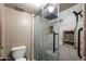 Tiled bathroom featuring a glass enclosed shower with rainfall shower head and a built-in toiletry niche at 5536 N Camelback Canyon Pl, Phoenix, AZ 85018