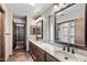 Bathroom featuring a double vanity, wood cabinets, tile floors, and a separate walk-in closet at 5536 N Camelback Canyon Pl, Phoenix, AZ 85018