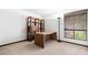 Bedroom with wooden desk and shelving, neutral carpet, natural light, and a floor lamp at 5536 N Camelback Canyon Pl, Phoenix, AZ 85018