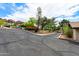 Expansive driveway with desert landscaping and mature trees at 5536 N Camelback Canyon Pl, Phoenix, AZ 85018