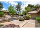 Professionally landscaped front yard with brick accents and mature desert trees at 5536 N Camelback Canyon Pl, Phoenix, AZ 85018
