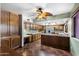Spacious kitchen featuring custom wood cabinetry, an island, tile countertops, and stainless-steel appliances at 5536 N Camelback Canyon Pl, Phoenix, AZ 85018
