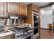 Close up of gas range with stainless hood and double ovens framed by custom cabinetry in the kitchen at 5536 N Camelback Canyon Pl, Phoenix, AZ 85018