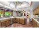 The large kitchen features an island with seating, bright sunny window, and opens to the living room at 5536 N Camelback Canyon Pl, Phoenix, AZ 85018