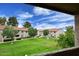 Balcony overlooking a well-maintained lawn area with mature trees at 623 W Guadalupe Rd # 279, Mesa, AZ 85210