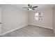 A cozy bedroom features wood look floors, a ceiling fan, and a window, creating a relaxing atmosphere at 623 W Guadalupe Rd # 279, Mesa, AZ 85210