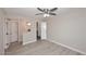 Bright bedroom featuring a ceiling fan, wood-look flooring and walk-in closet at 623 W Guadalupe Rd # 279, Mesa, AZ 85210