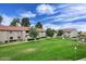 Community lawn area with walking paths and mature shade trees at 623 W Guadalupe Rd # 279, Mesa, AZ 85210