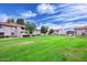 Condominiums overlook a large green space with scattered trees against a vibrant blue sky at 623 W Guadalupe Rd # 279, Mesa, AZ 85210