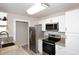 Updated kitchen with stainless steel appliances, granite countertops, and white cabinets at 623 W Guadalupe Rd # 279, Mesa, AZ 85210
