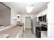 A modern kitchen with white cabinets, stainless steel appliances and granite countertops provides an efficient workspace at 623 W Guadalupe Rd # 279, Mesa, AZ 85210