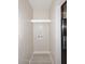 An interior laundry area with wood look flooring, white shelf, and washer hook-ups provides added convenience at 623 W Guadalupe Rd # 279, Mesa, AZ 85210