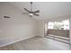 Bright living room with sliding door, wood-look floors, neutral walls, and ceiling fan at 623 W Guadalupe Rd # 279, Mesa, AZ 85210