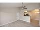 Open-concept living space with wood-look floors flowing into the kitchen and neutral paint at 623 W Guadalupe Rd # 279, Mesa, AZ 85210