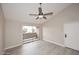 Bright living room with sliding door, wood-look floors, neutral walls, and ceiling fan at 623 W Guadalupe Rd # 279, Mesa, AZ 85210