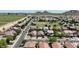 Wide aerial view of a neighborhood featuring tree-lined streets and a large field at 641 W Mesquite Tree Ln, San Tan Valley, AZ 85143