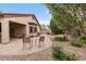 Paver patio with shaded seating area and view of the nicely landscaped backyard at 641 W Mesquite Tree Ln, San Tan Valley, AZ 85143