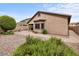 Exterior view of home with a neutral color, xeriscaped backyard with a brick paver patio at 641 W Mesquite Tree Ln, San Tan Valley, AZ 85143