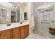 Modern bathroom featuring a double vanity, glass shower, and a walk-in closet at 641 W Mesquite Tree Ln, San Tan Valley, AZ 85143