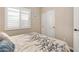 Cozy bedroom with a window dressed with plantation shutters and a sliding door closet at 641 W Mesquite Tree Ln, San Tan Valley, AZ 85143