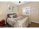 A serene bedroom features soft lighting, a window with plantation shutters, and calming decor at 641 W Mesquite Tree Ln, San Tan Valley, AZ 85143