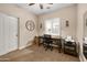 A well-lit bedroom featuring a desk, comfortable chair, window, and closet with mirrored doors at 641 W Mesquite Tree Ln, San Tan Valley, AZ 85143