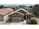 Charming single-story home showcasing a two-car garage and low-maintenance desert landscaping at 641 W Mesquite Tree Ln, San Tan Valley, AZ 85143