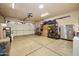 Spacious garage with epoxy floors, overhead lighting, and room for storage and organization at 641 W Mesquite Tree Ln, San Tan Valley, AZ 85143