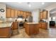 Well-lit kitchen with wooden cabinetry, stainless steel appliances, and granite countertops at 641 W Mesquite Tree Ln, San Tan Valley, AZ 85143