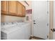 Bright laundry room offering a washer, dryer, storage cabinets, and a convenient folding area at 641 W Mesquite Tree Ln, San Tan Valley, AZ 85143