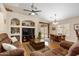 Open concept living area featuring a ceiling fan, large sofa, and dining table with backyard access at 641 W Mesquite Tree Ln, San Tan Valley, AZ 85143