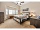 Bright main bedroom with a bay window, plush carpeting, and neutral decor at 641 W Mesquite Tree Ln, San Tan Valley, AZ 85143