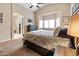 Spacious bedroom featuring a bay window and ensuite bathroom access, perfect for relaxation at 641 W Mesquite Tree Ln, San Tan Valley, AZ 85143