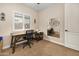 Well-lit home office featuring a wooden desk, comfortable chair, and modern decor, perfect for a productive workspace at 641 W Mesquite Tree Ln, San Tan Valley, AZ 85143