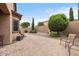 Paver patio with seating offers a relaxing outdoor space, surrounded by mature landscaping at 641 W Mesquite Tree Ln, San Tan Valley, AZ 85143