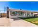 Charming single-story home featuring a well-maintained lawn, brick accents, and a welcoming front entrance at 6821 W Mariposa St, Phoenix, AZ 85033