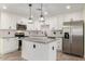 Modern kitchen with stainless steel appliances, granite countertops, an island, and stylish pendant lighting at 6821 W Mariposa St, Phoenix, AZ 85033