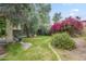 Serene backyard featuring a mix of greenery, flowering plants, and comfortable seating at 6858 W Potter Dr, Glendale, AZ 85308