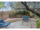 Private backyard with mature trees, flowering shrubs, and comfortable seating at 6858 W Potter Dr, Glendale, AZ 85308