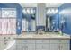 Bathroom showcasing a double sink vanity with granite countertop and matching mirrors at 6858 W Potter Dr, Glendale, AZ 85308