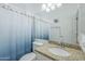 Bright bathroom features a sink with granite countertop and a blue-themed shower curtain at 6858 W Potter Dr, Glendale, AZ 85308
