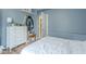 Comfortable bedroom featuring light blue walls, white dresser, and an open door to the closet at 6858 W Potter Dr, Glendale, AZ 85308