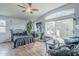 Bedroom with hardwood floors, a ceiling fan, a large window, and a sliding glass door at 6858 W Potter Dr, Glendale, AZ 85308