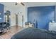 Bedroom with hardwood floors, an arched doorway and a blue accent wall at 6858 W Potter Dr, Glendale, AZ 85308