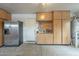 Garage features cabinets, shelving and a refrigerator at 6858 W Potter Dr, Glendale, AZ 85308