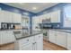 Well-lit kitchen with stainless steel appliances, island, and white cabinetry at 6858 W Potter Dr, Glendale, AZ 85308
