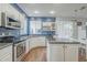 Bright kitchen featuring white cabinets, stainless steel appliances, and dark countertops at 6858 W Potter Dr, Glendale, AZ 85308