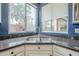 Granite countertops, white cabinets, and a double-basin sink overlooking a window at 6858 W Potter Dr, Glendale, AZ 85308