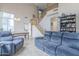 Open-concept living room with high ceilings, a staircase, and comfortable seating at 6858 W Potter Dr, Glendale, AZ 85308